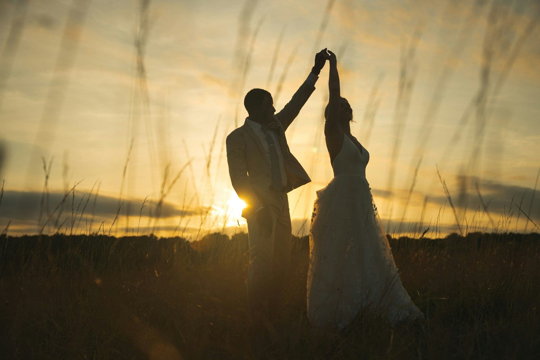 Amara and Daniel dancing in the vines at sunset